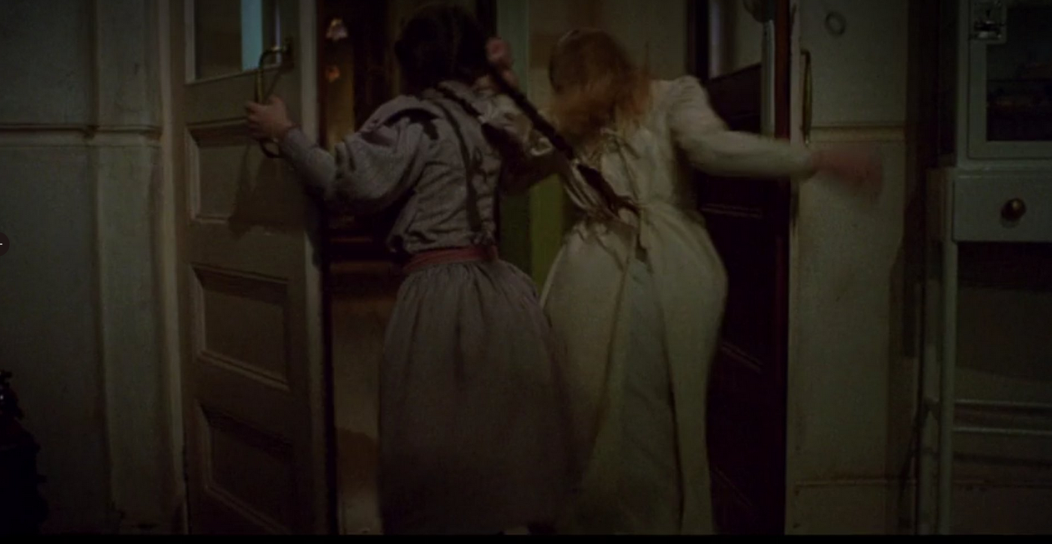 Ozma and Dorothy going through a door
