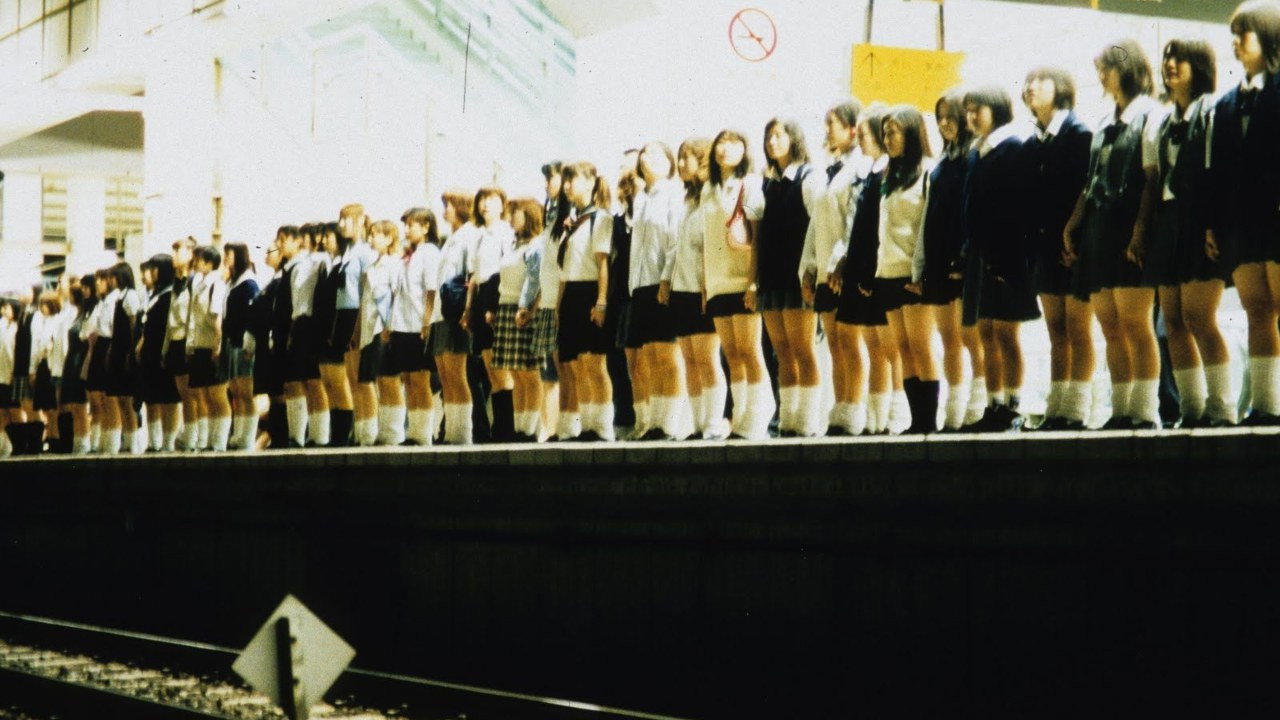 The film's opening: dozens of schoolgirls line the platform, hand in hand, seconds before they jump